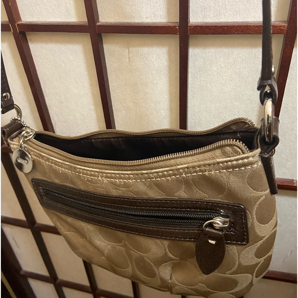 Coach tan and brown monogram sling bag. Interior is a bit dirty.